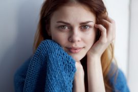 portrait of young woman near a window