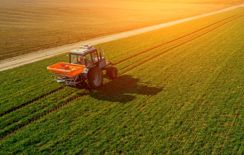 tractor on a green field. aerial survey of agriculture