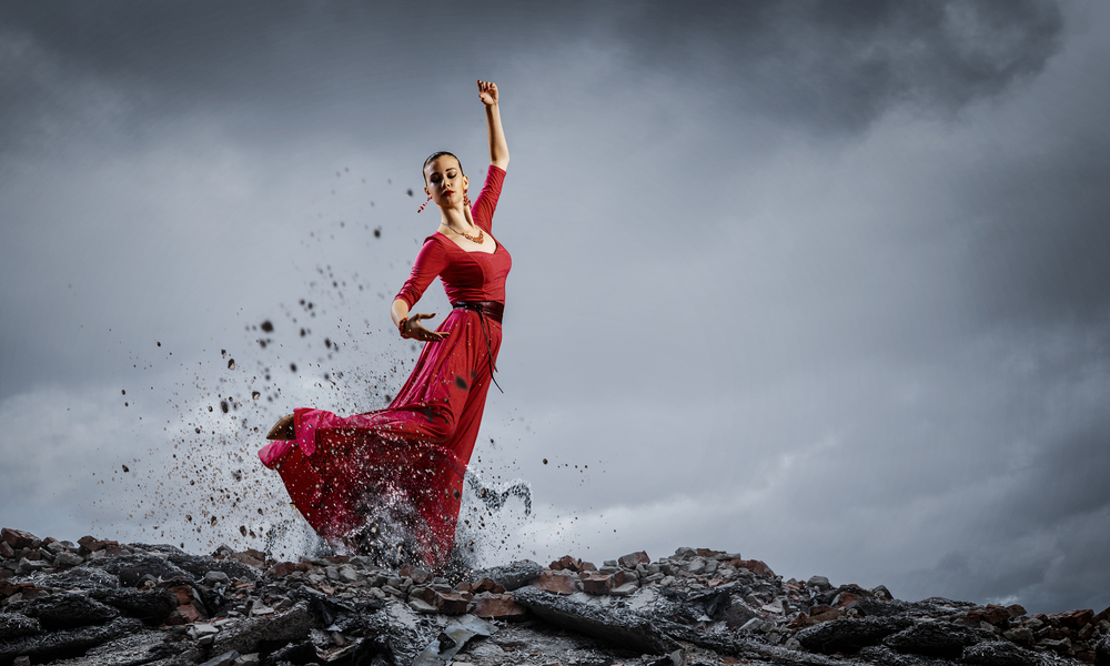 Young beautiful woman in red dress and natural landscape